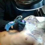 chestpiece lettering tattoo